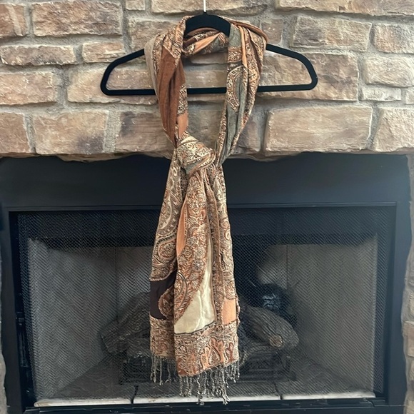 Autumn colored scarf with a mixture of browns and orange with fringe